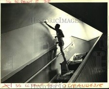 1987 Press Photo Bennie Huxen paints a stair well at Metairie Grammer School picture