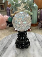 Aura coated quartz crackle sphere with black resin stand picture