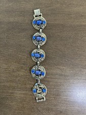 Vintage Gold toned metal link bracelet with deep blue cabochons speckled with go picture