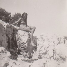 Young Bikini Woman Sitting High On Bright Sunlit Seaside Rocks Vintage Photo picture