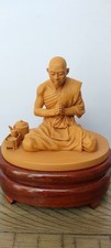 Buddhist Monk Statue praying meditating on a pedestal.  picture