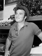 American actor Burt Reynolds smiles leans an automobile wearing a - Old Photo picture