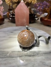 Copper rutile sphere with metal snake holder picture