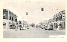 H60/ Julesburg Colorado Postcard c1940s Main Street Stores Automobiles 1 picture