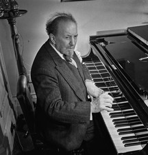 English conductor Sir Henry Wood plays a grand piano as he celebra- Old Photo picture