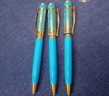 (Lot of 13) Disney *Aladdin* ballpoint pen in gold-tone metal and blue enamel. picture