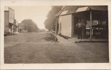 RPPC Nice Town Street Scene Man Posing at Store Front c. 1910 picture