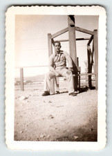 Photo Man In Uniform Seated On Wooden Structure Outdoor Snapshot Vintage 1940s picture