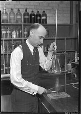 Man adjusting a burner under a beaker California Old Photo picture