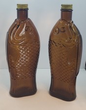 Pair of Vintage 1930s Fish shaped Amber Glass Cod Liver Oil bottle original cap picture