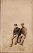 RPPC 2 Soldiers Outdoor Sitting On A Rock, Real Photo Postcard  picture