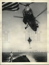 1955 Press Photo John Davis Lodge lifted by Naval Helicopter during training picture