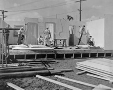 Construction workers assembly a prefabricated building early stage- Old Photo picture