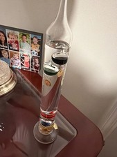 Vintage multi-colored glass Galileo thermometer with metallic tags picture