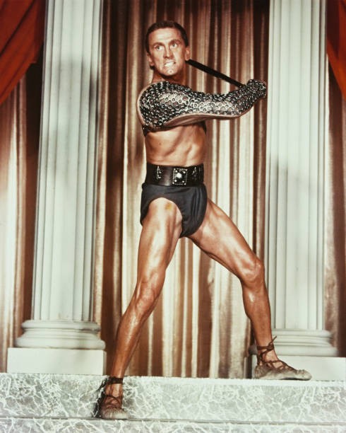 American actor Kirk Douglas plays gladiator leader a Roman slave r- Old Photo
