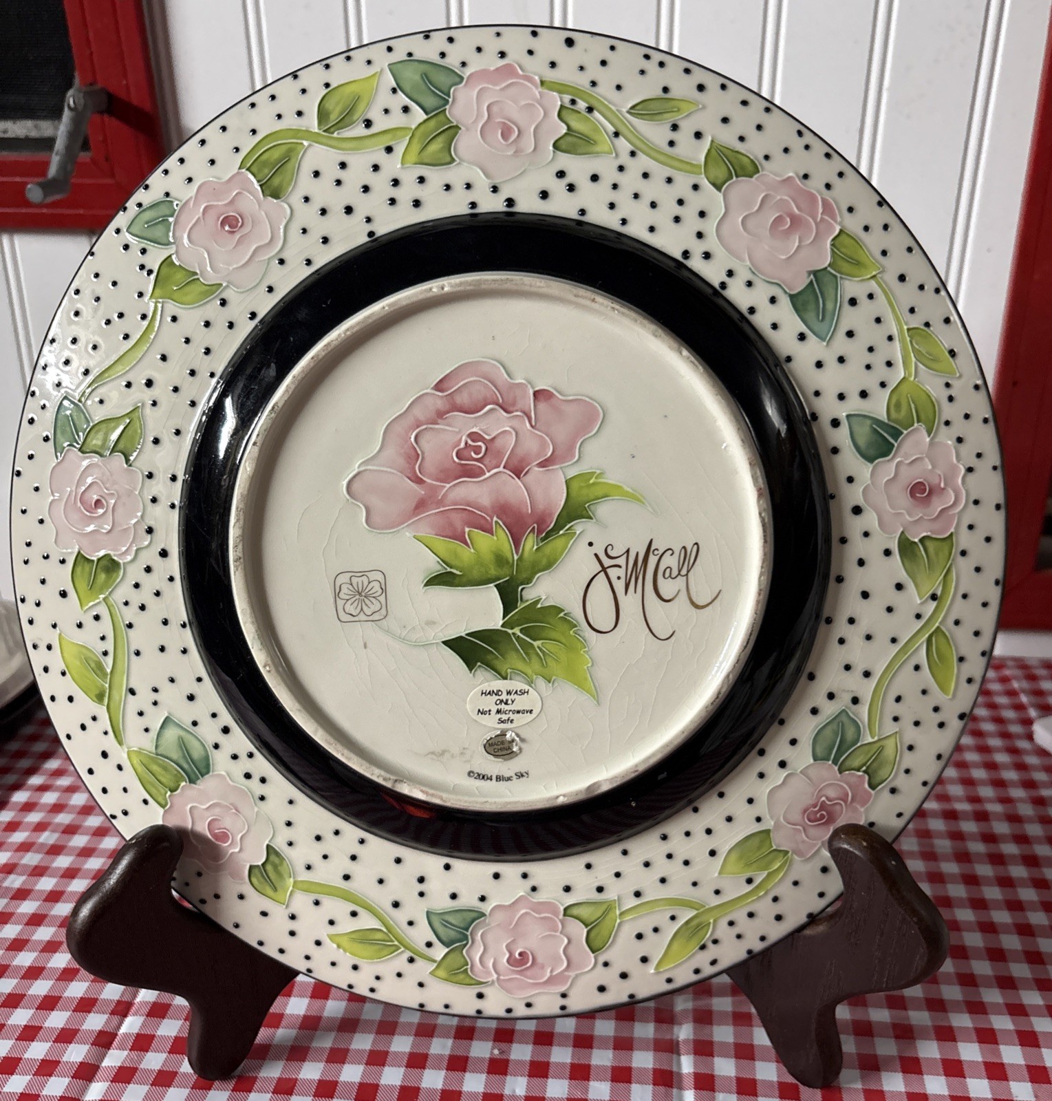 A 12-inch J McCall Blue Sky decorative plate with a floral rose pattern.