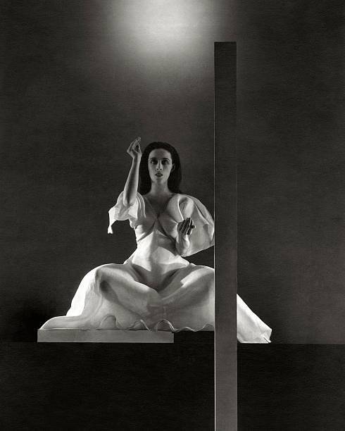 Martha Graham seated in a lotus position during a performance of 1930s Old Photo