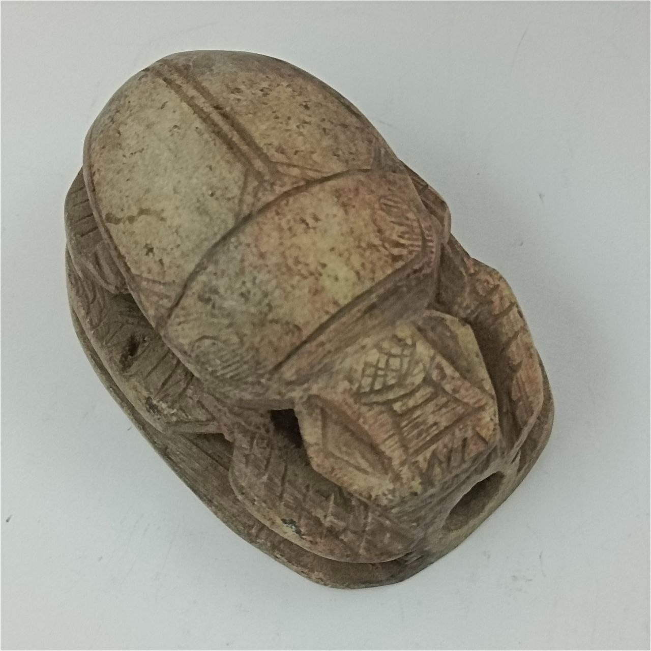 Rare Egyptian scarab with hieroglyphs, unique pharaonic style.