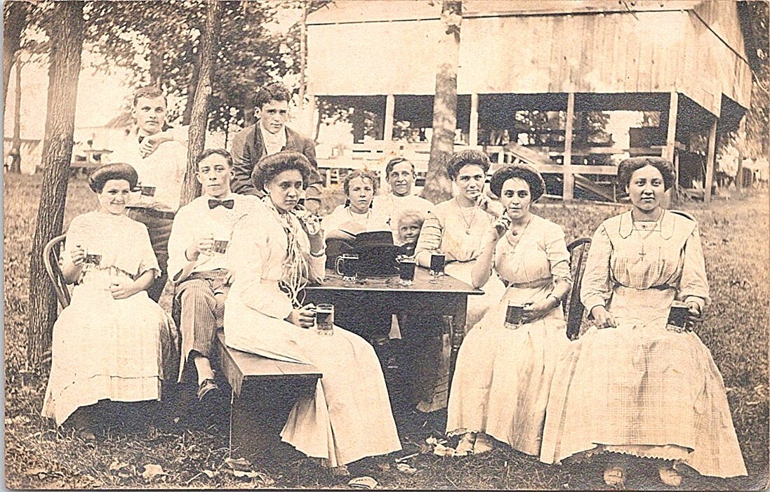 RPPC Young Women in White Dresses Sitting in Park Drinking Beer early 1900s