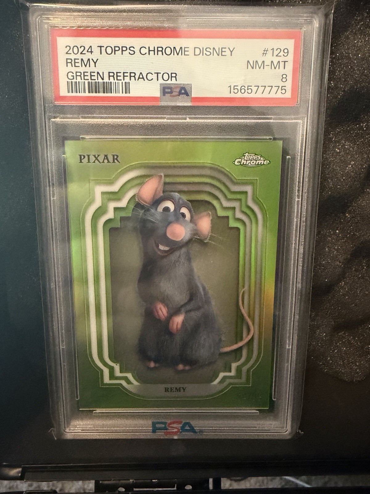 Topps 2024 Topps Chrome Disney Pixar Remy Green Refractor #129 PSA 8