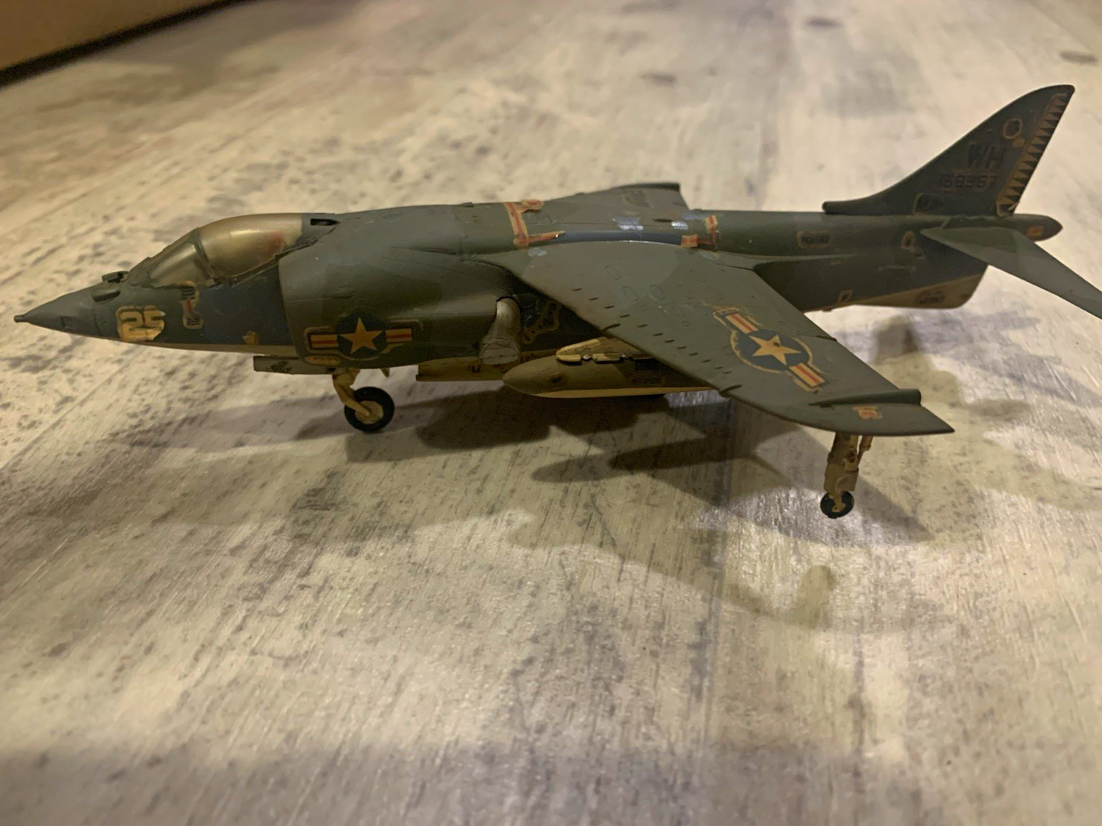 US Marines AV-8 Harrier jet desk/shelf model in green/gray camouflage.