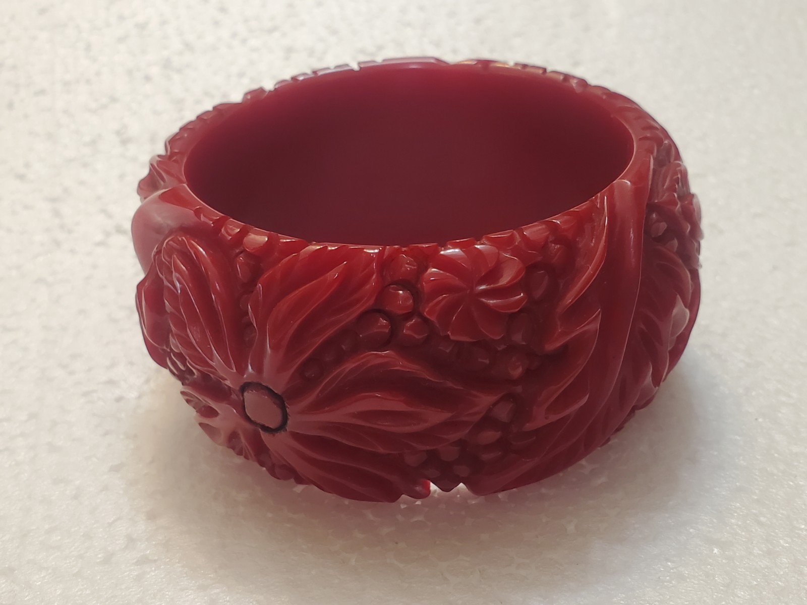 Vintage Cherry Red Bakelite Bangle Bracelet with a carved floral design