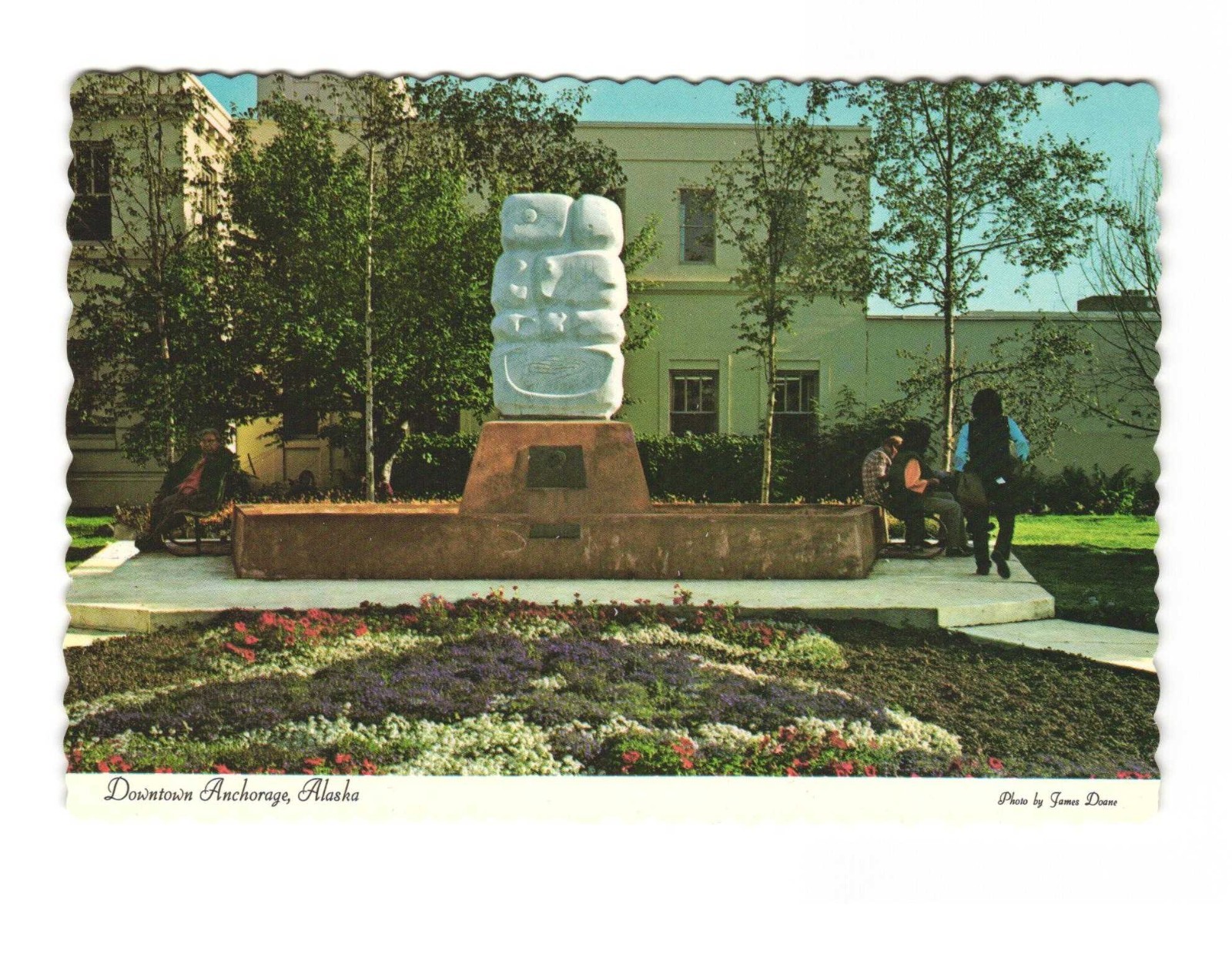 Downtown Acreage AK flowers and sculpture in front of City Hall VTG postcard Unp