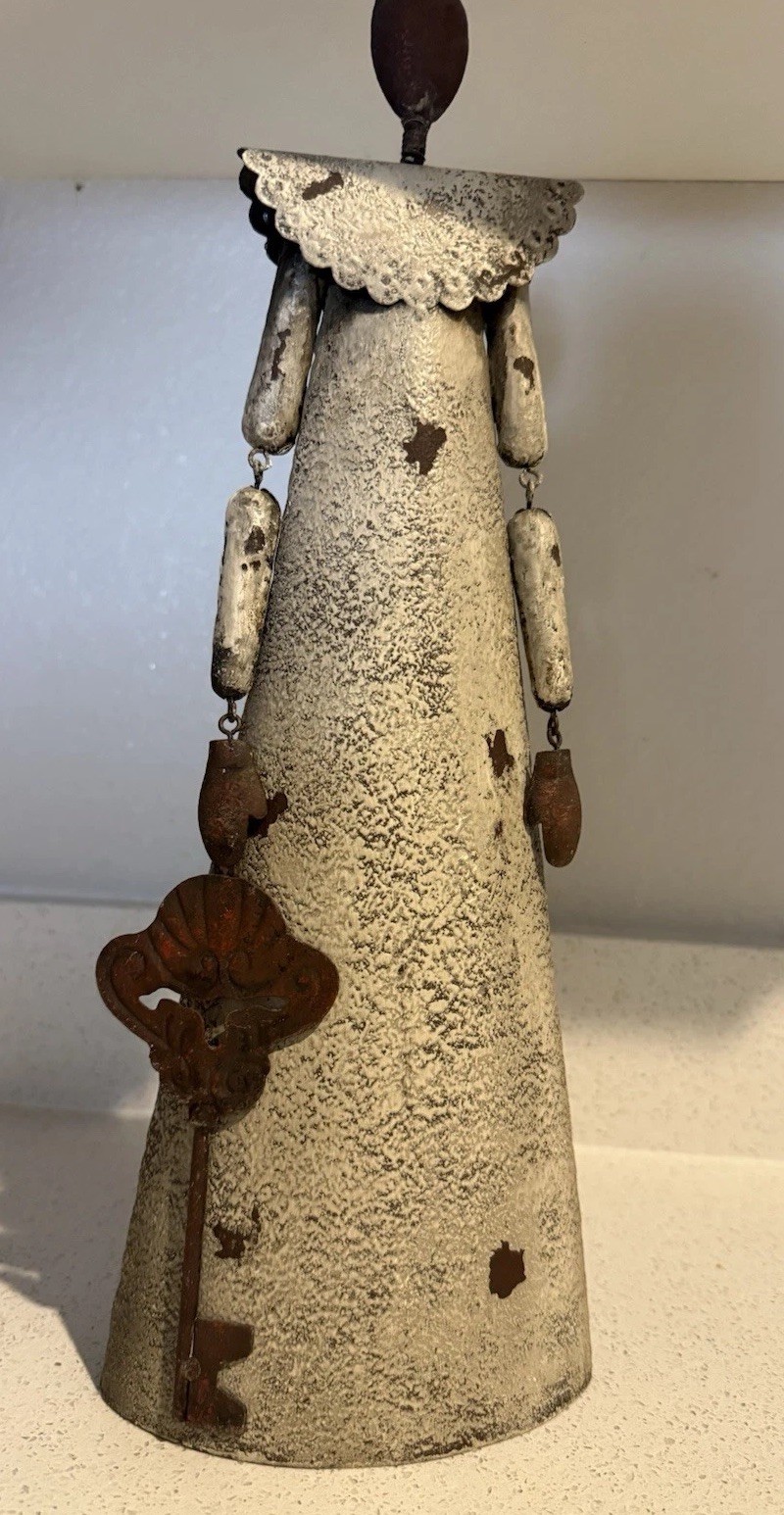 VTG decorative rustic metal sculpture of a stylized figure holding a large key.