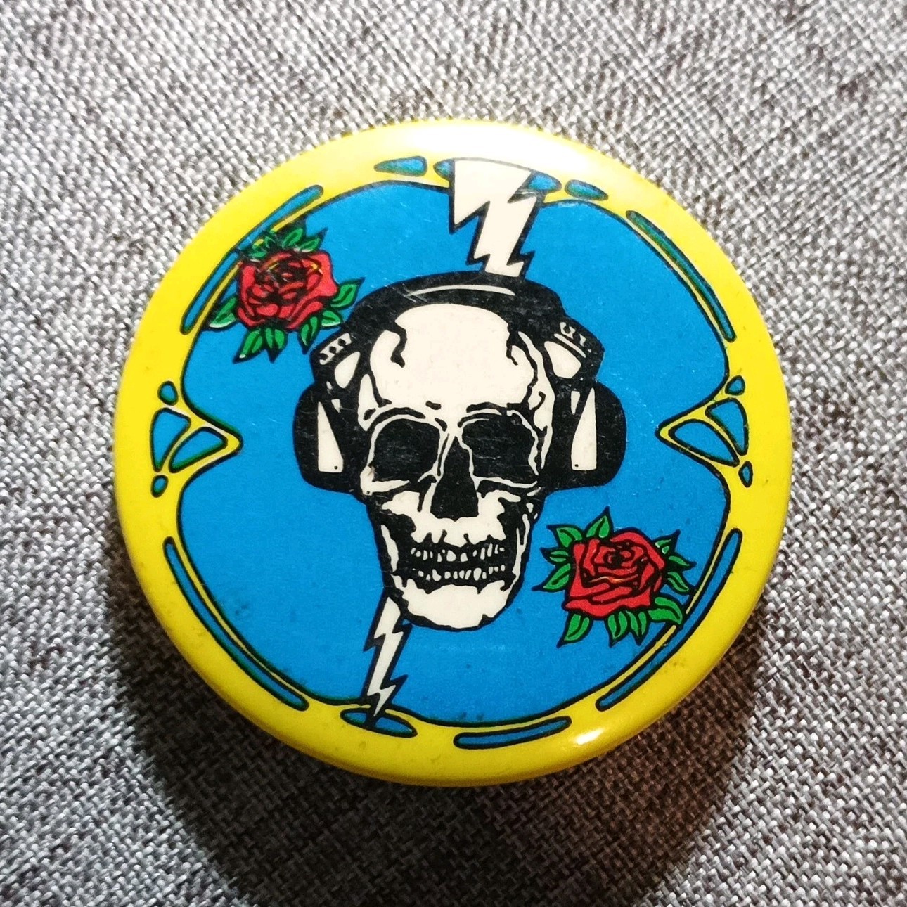 Vintage Grateful Dead pinback button Skull with Headphones & Roses Light. Bolt