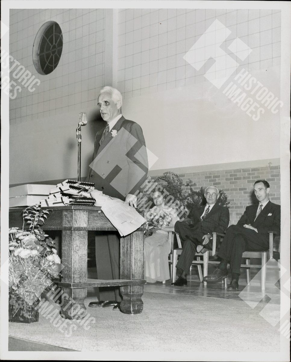 1956 Former President Wilson Compton speaking at a podium