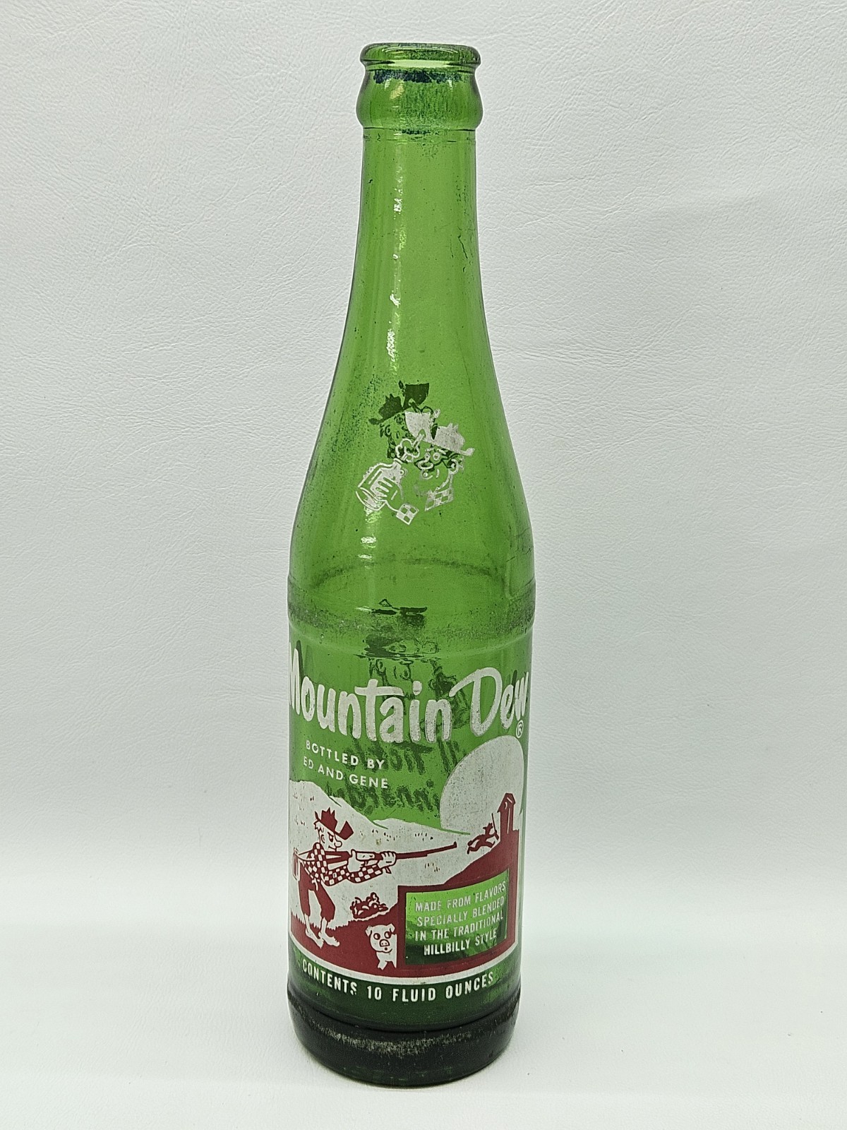 MOUNTAIN DEW 10 oz. HILLBILLY SODA BOTTLE - By Lou And Joann IT\'LL TICKLE YORE