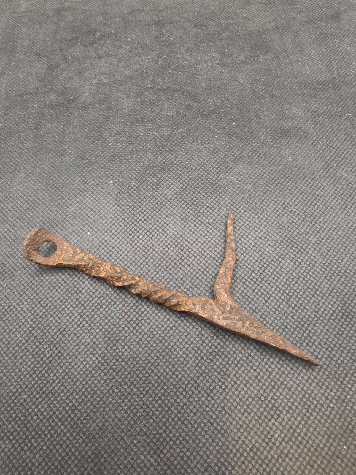 antique hand-forged iron harpoon or barbed arrow point featuring a looped eyelet