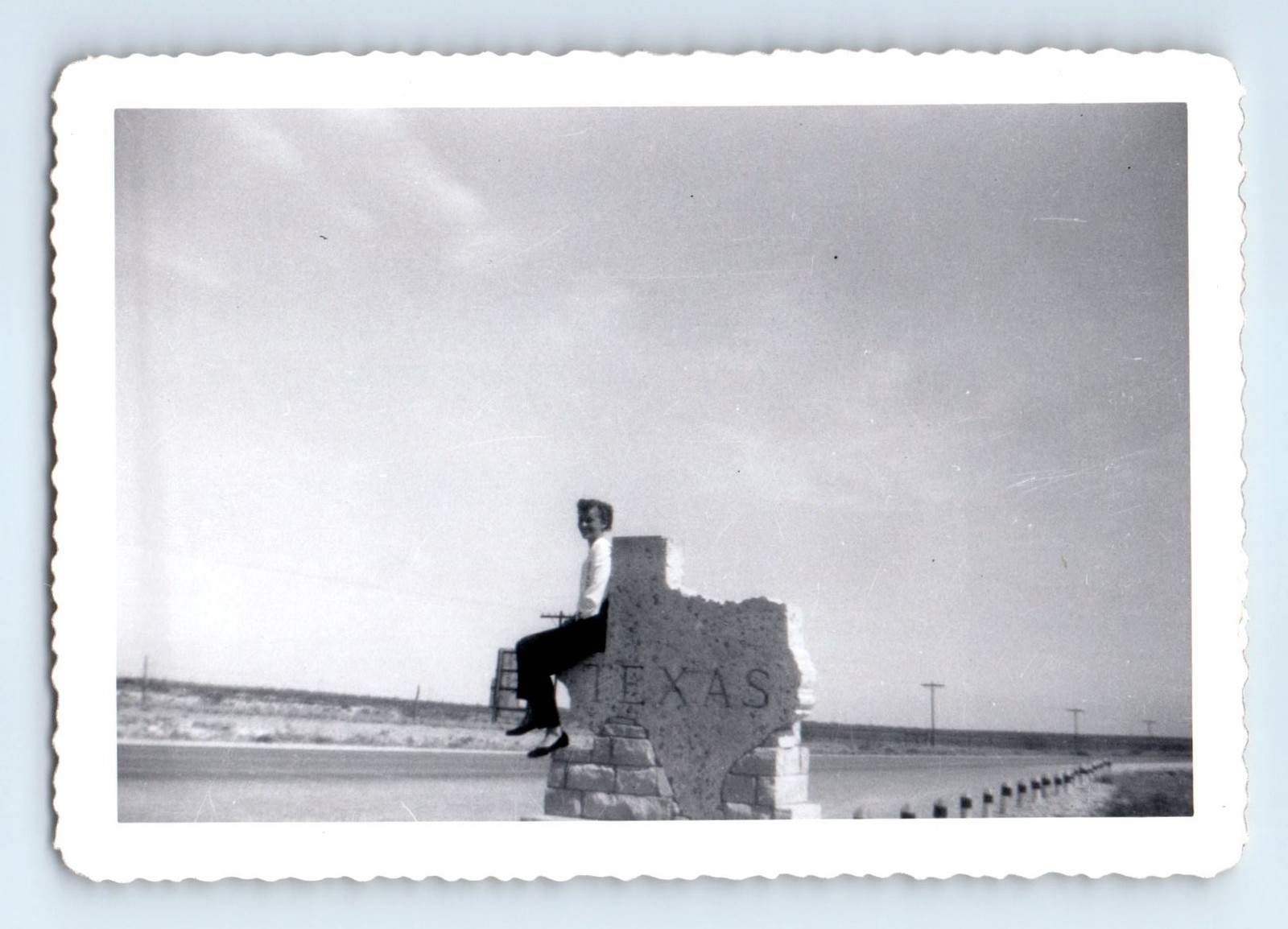Old Vintage Photo WOMAN SITTING ON TEXAS HIGHWAY SIGN SNAPSHOT