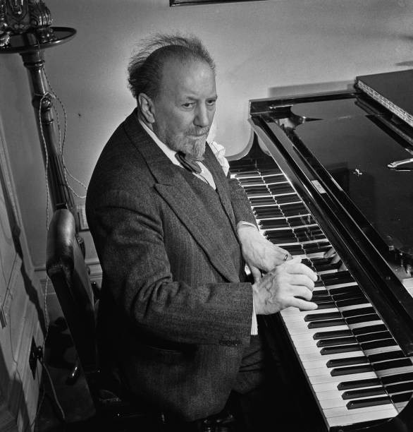 English conductor Sir Henry Wood plays a grand piano as he celebra- Old Photo