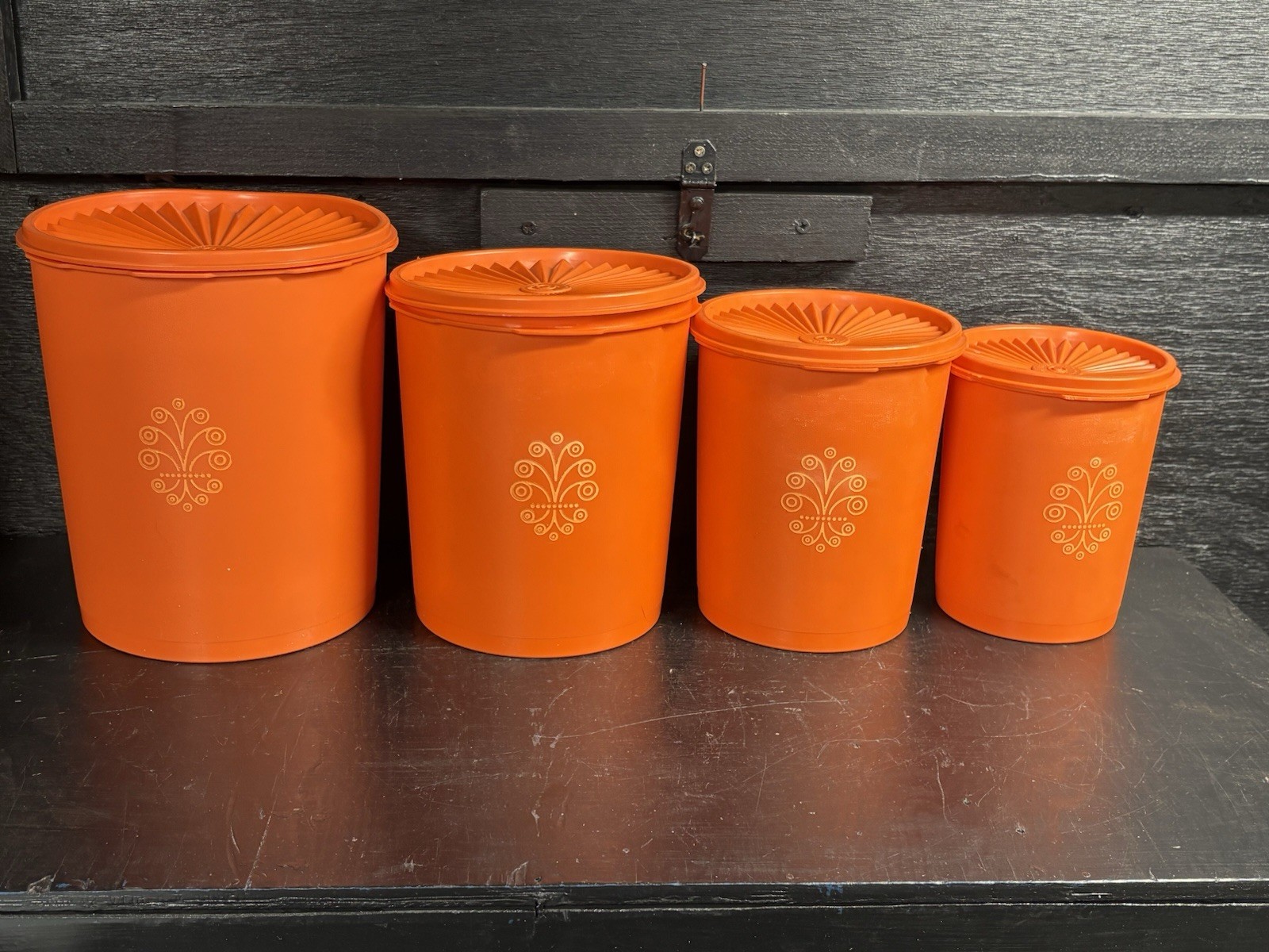 A Set Of Vintage Tupperware Servalier Orange Nesting Canister Set With Lids
