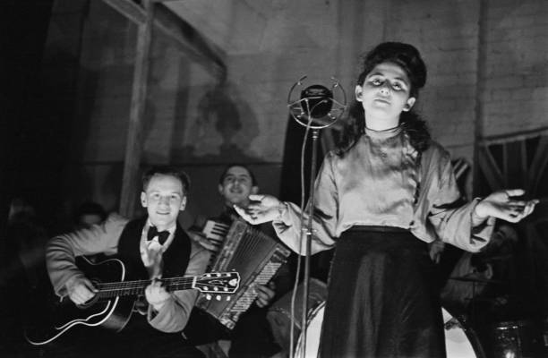 Shop worker Sadie Davis entertains fellow employees a song Dick- 1941 Old Photo