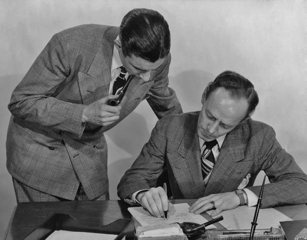 Two men checking a document in the office circa 1940's Historic Old Photo