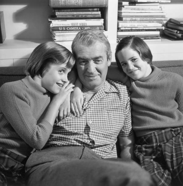 American film actor James Stewart sitting a couch smiling twin dau- Old Photo