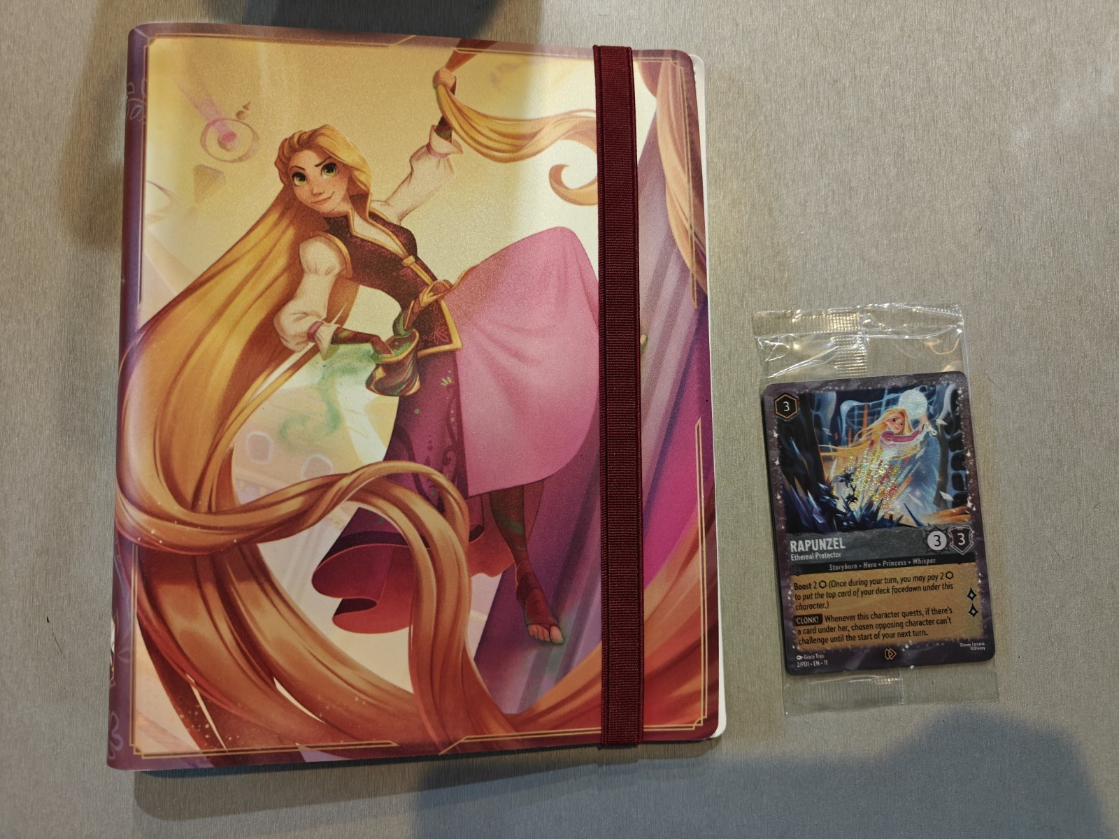 Open box Disney Lorcana Rapunzel Edition Collector's portfolio with PROMO CARD