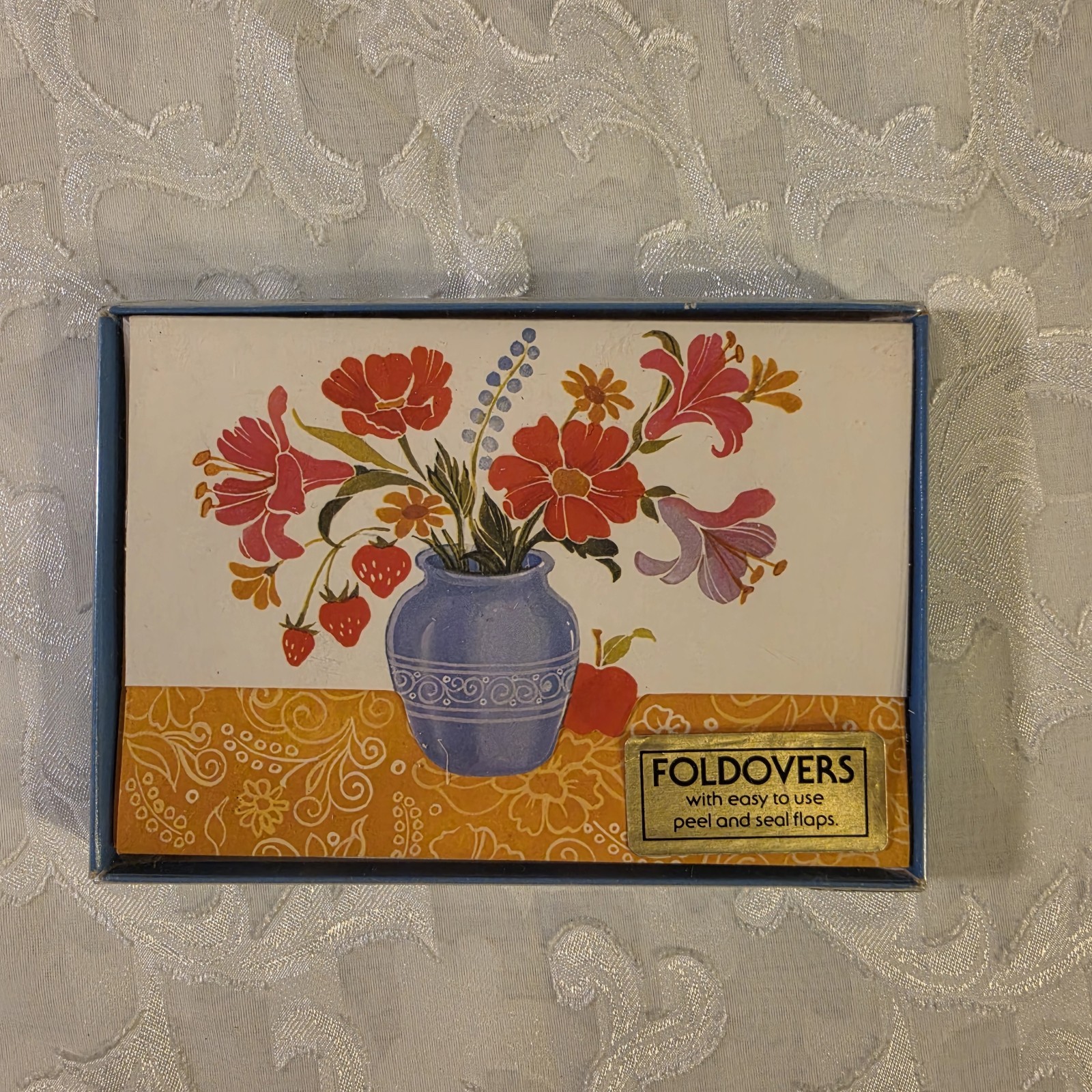 1970s vintage box of Foldovers stationery featuring a retro floral-in-a-vase