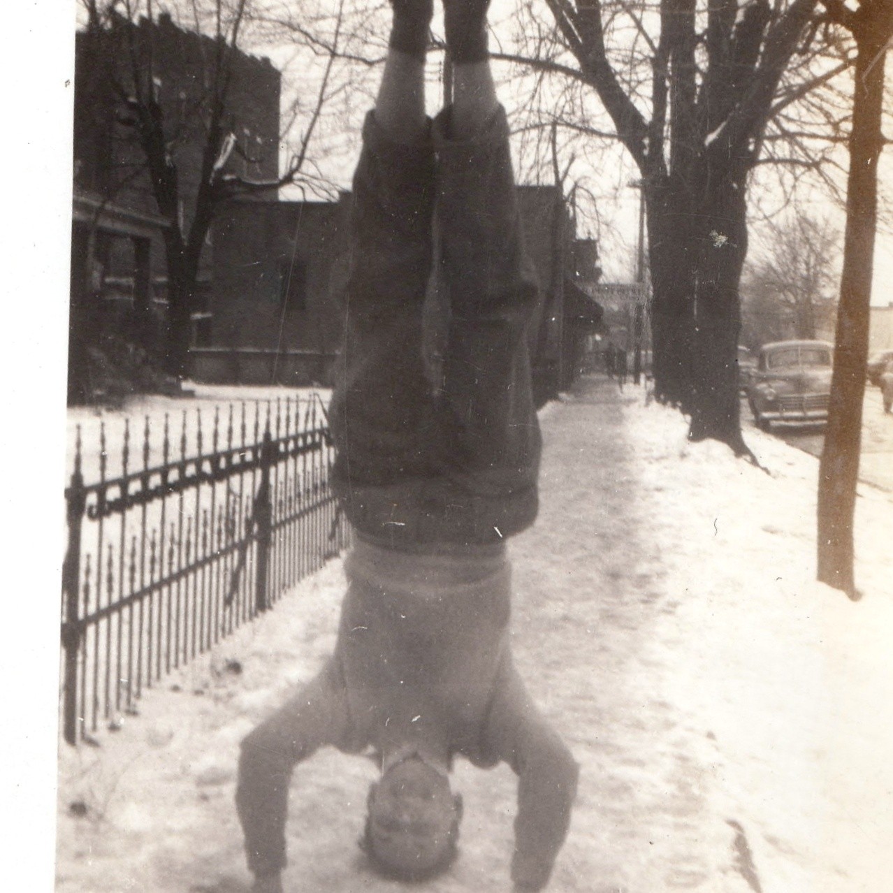 c1940s Boy Doing Headstand in Snow Sidewalk Snapshot Photo Fence Winter Cars Vtg