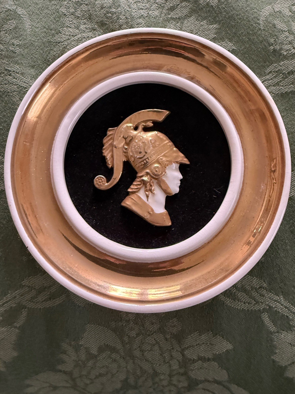 An antique 1930’s decorative wall plate with gilt profile of Alexander the Great