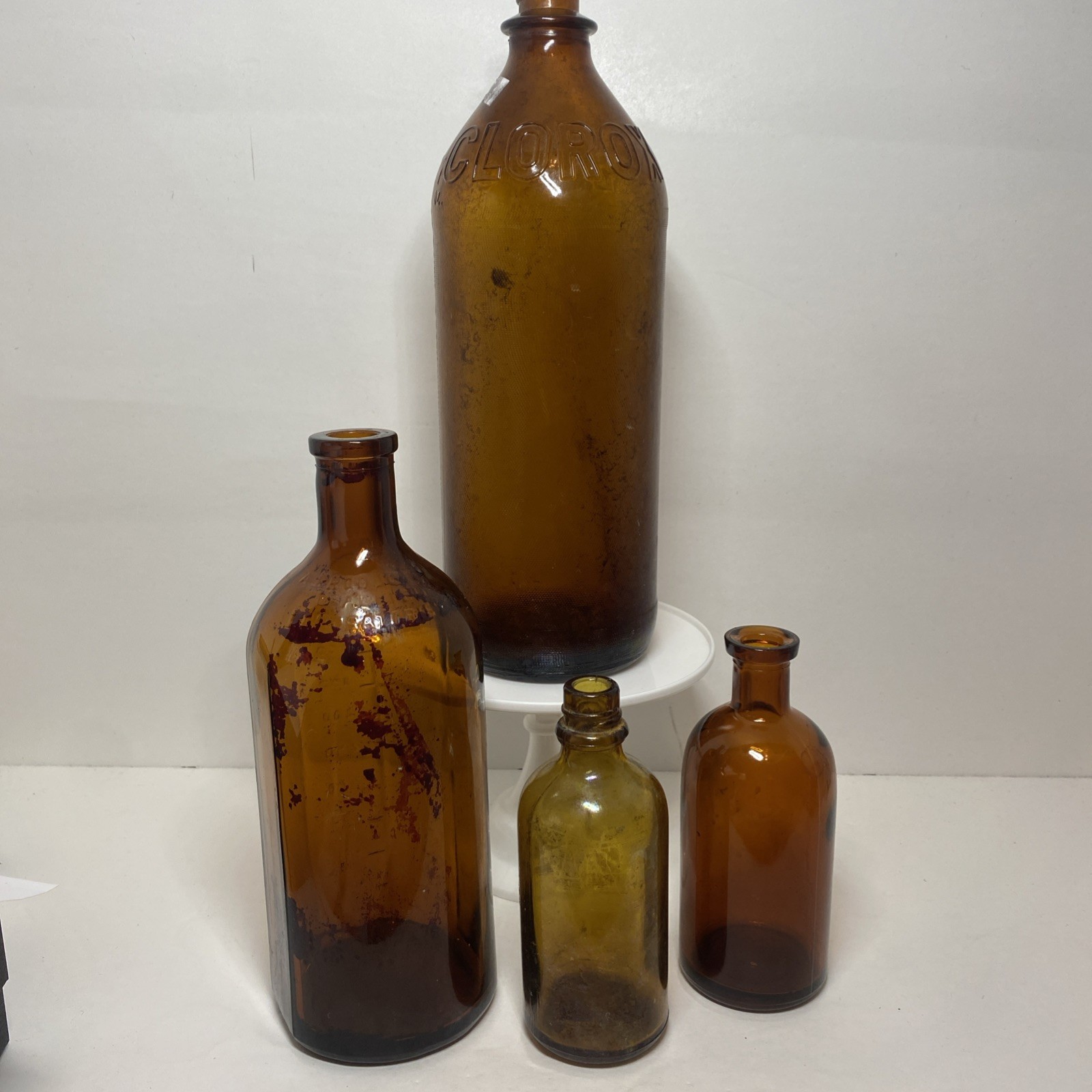 Lot Of 4 Antique VTG Mixed Use Amber Bottles Marked On Bottom 2 Large 2 Small