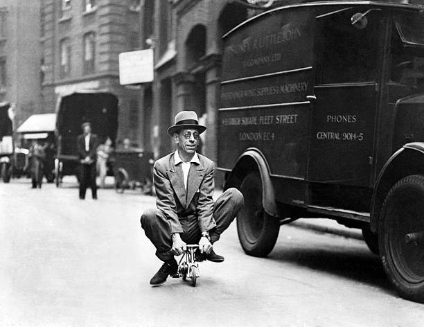 Smallest cycle in city in a tabb a motor cycle engineer riding thr- Old Photo