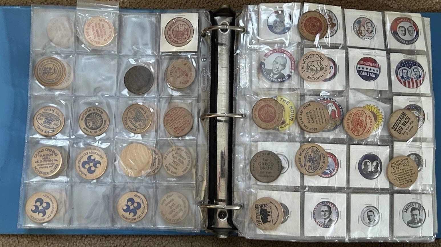 LARGE ALBUM FULL OF HUNDREDS OF VINTAGE WOODEN NICKELS, POLITICAL PINS IN BINDER