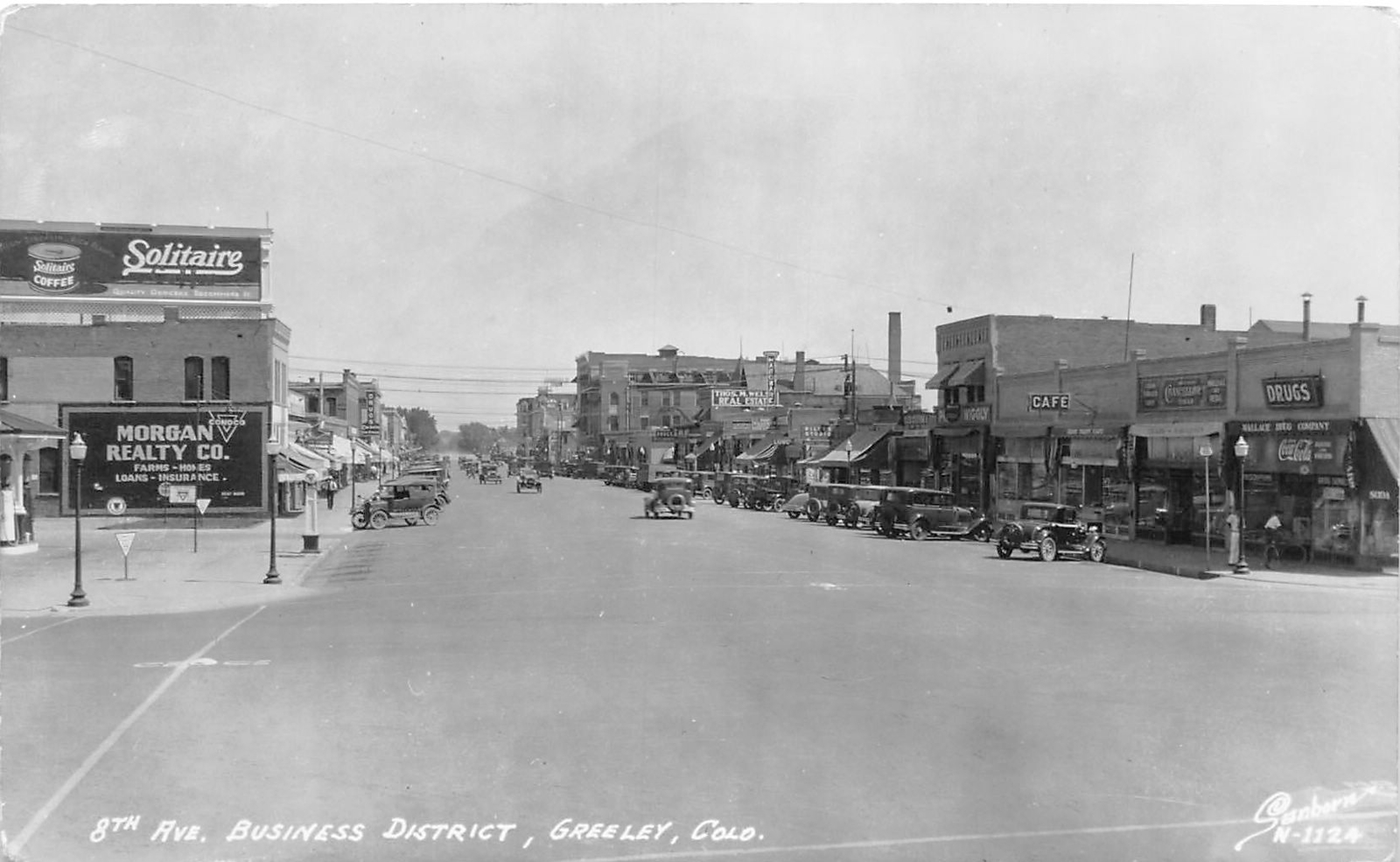 H32/ Greeley Colorado RPPC Postcard c1940s 8th Ave Business Stores Autos