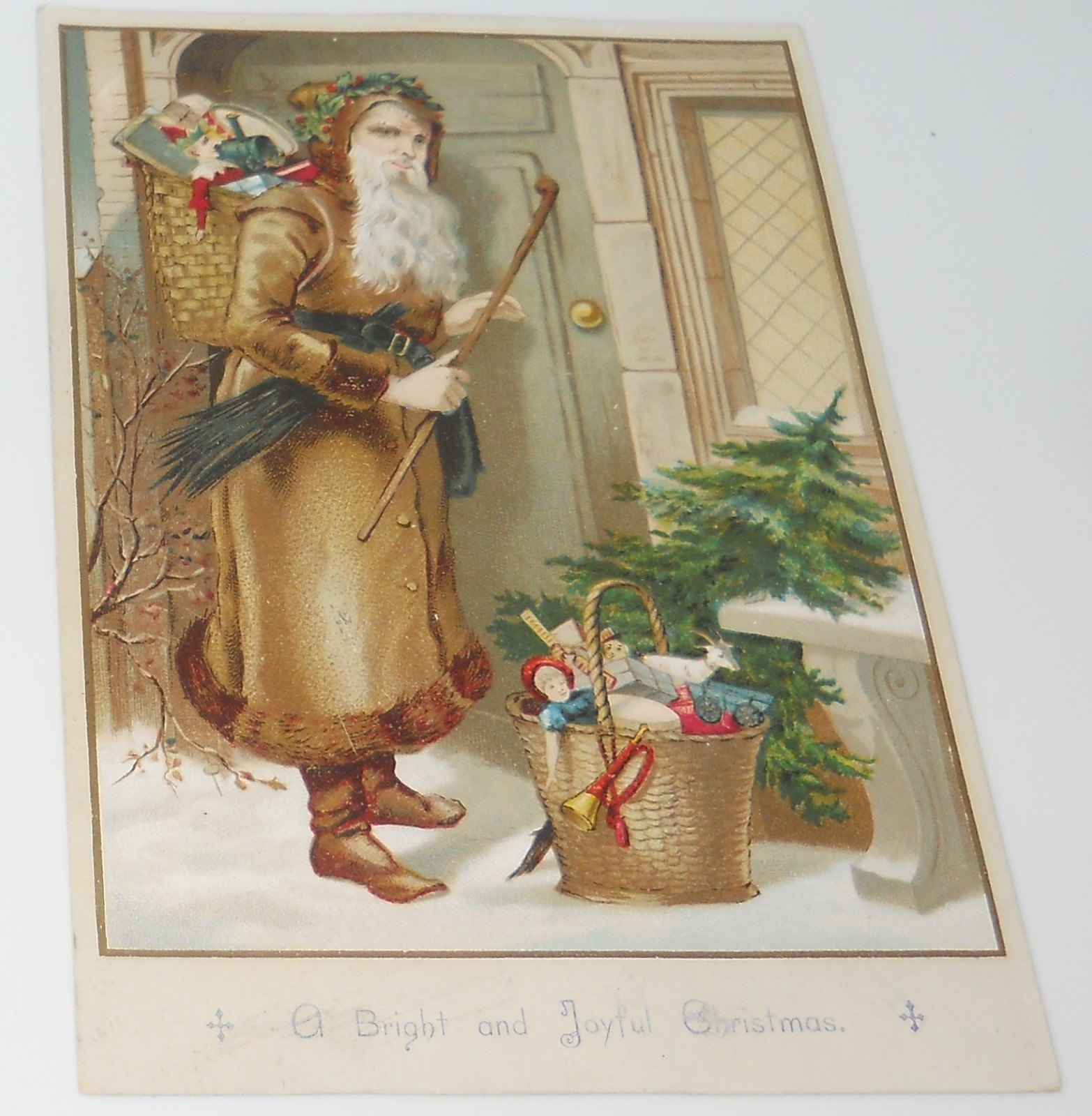 SCARCE ANTIQUE CHRISTMAS TRADE CARD SANTA CANE BASKET TOYS DOORWAY SNOW TREE