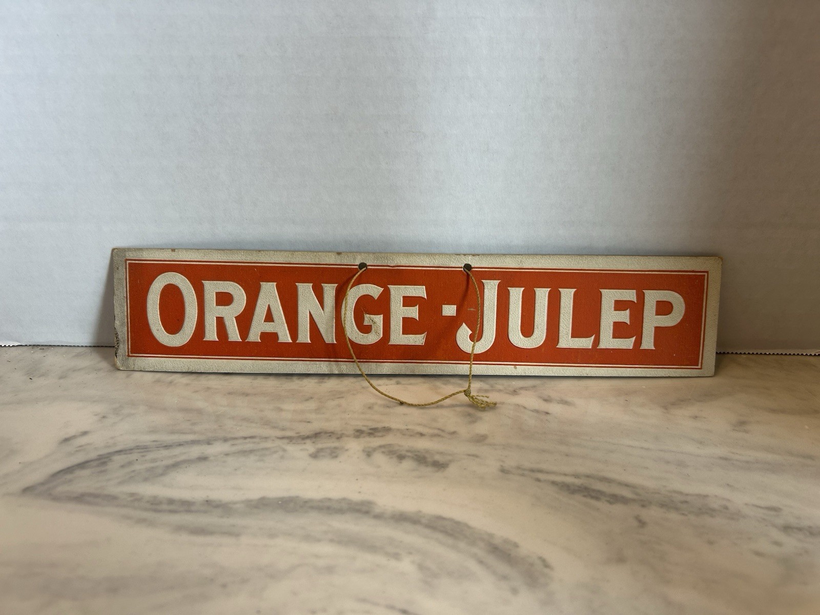 Orange-Julep embossed cardboard hanging Sign , likely from the 1920s–1930s.