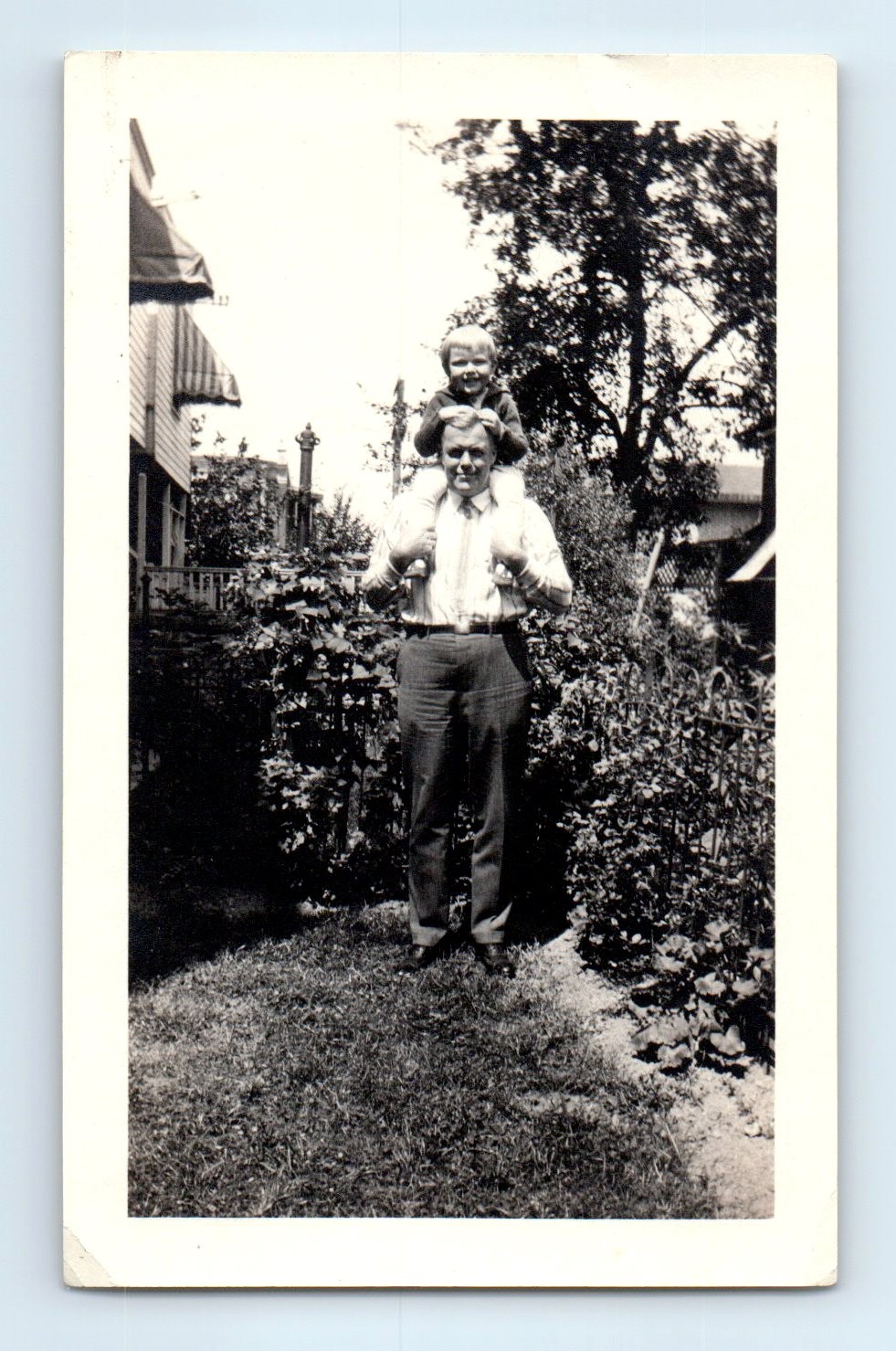 Old Vintage Photo BOY SITTING ON SHOULDERS OF MAN OUTSIDE HOUSE IN YARD