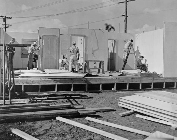 Construction workers assembly a prefabricated building early stage- Old Photo